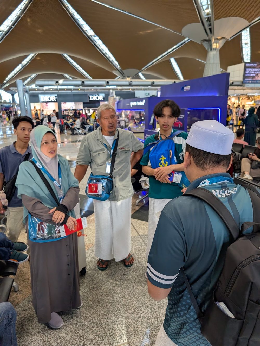 A coordinator reviewing travel documents and briefing travellers before departure