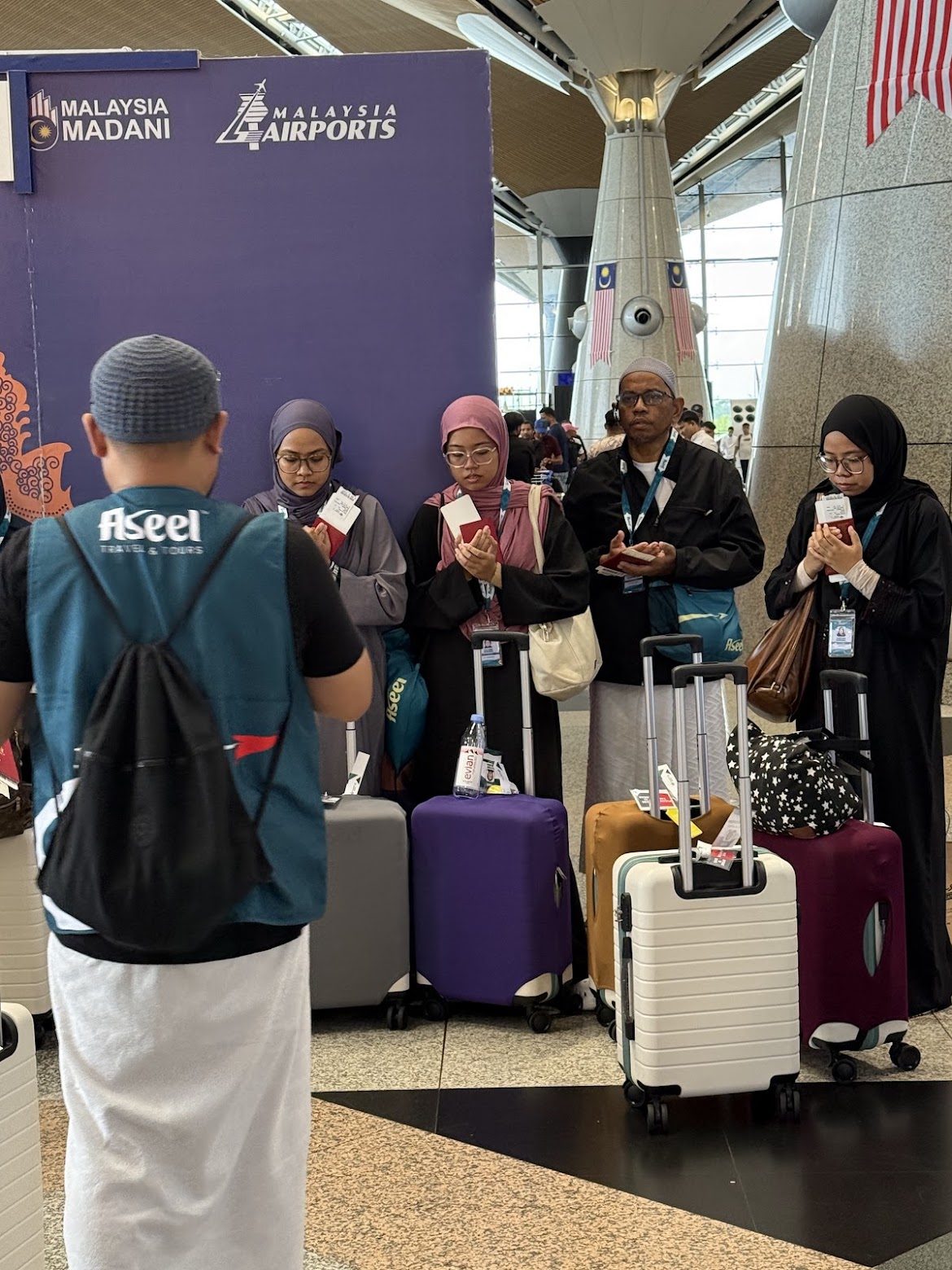 A traveller walking through a bright airport departure hall, luggage in hand